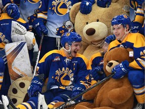 Saskatoon Blades captain Evan FIala and his teammates are all smiles as they cozy up to the big teddy bear after the annual Teddy Bear Toss. The Blades went on to win the game 3-2 over the rival Prince Albert Raiders.