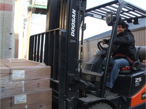 Warehouse assistant Kyle Lumberjack maneuvers pallets packed with a donation of frozen chickens at the Saskatoon Foodbank and Learning Centre on Wednesday Dec. 13, 2017.  The donation, which was provided by the Saskatchewan Chicken Farmers and Sofina Foods, consisted of 2,000 frozen chickens.  Kari Tosczak, executive director of the Saskatchewan Chicken Farmers and Will Brown, a plant manager with Sofina Foods, were on hand for Wednesday's donation.  Both said they felt it was important to supply the food bank with the donation, so families in Saskatoon can have access to locally-sourced, nutritious food this holiday season.  The Saskatoon Food bank and Learning Centre is currently working to raise $400,000 and collect 400,000 pounds of food as part of its annual Tree of Plenty campaign. (Morgan Modjeski/The Saskatoon StarPhoenix)