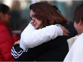 Family members comfort Alyssa Bird, the mother of six-week-old Nikosis Jace Cantre, outside Saskatoon provincial court on Dec. 14, 2017. Bird has been attending the sentencing hearing of the teen girl who murdered her son last summer.