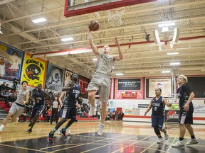 St. Joseph Guardians player Keagan White jumps up to make a basket during a qualifying game to play at BRIT (The Bedford Road Invitational Tournament) at Bedford Road in Saskatoon on Dec. 19, 2017.