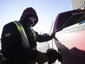 Kody Lyons pumps gas during a cold weather warning at the Saskatoon Co-op Gas Bar on 8th St E in Saskatoon, SK on Friday, December 29, 2017.