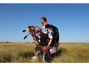 TJ Warren lifts up his six-year-old daughter Kiihibaa Acahkos Warren at Wanuskewin Heritage Park. "I want my daughters to continue on the compassion that we have as First Nations people to not only ourselves but the world."