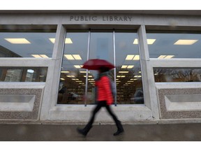 A woman walks past the Frances Morrison Central Library downtown Saskatoon on March 22, 2017.