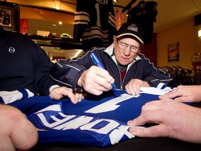 Johnny Bower, shown signing autographs in Victoria in 2011, was endlessly accommodating to hockey fans.