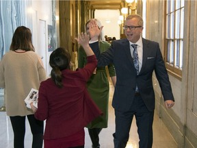 Premier Brad Wall high fives a staff member after his last question period as premier at the Legislative Building in Regina.
