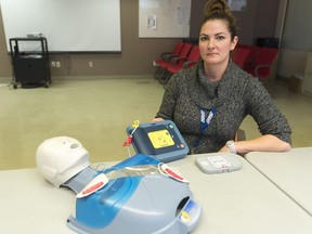 Amber Gorman, co-ordinator of the Public Access Defibrillator Program for Regina and area, demonstrates an Automated External Defibrillator at EMS Central Headquarters.