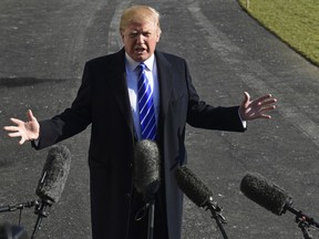 FILE - In a Saturday, Dec. 16, 2017 file photo, President Donald Trump talks with reporters as he departs from the South Lawn of the White House via Marine One in Washington, to spend the weekend at Camp David in Maryland. President Donald Trump's team on Sunday was again forced to grapple with the growing Russia probe that has shadowed the White House for much of the president's initial year in office. Special counsel Robert Mueller has gained access to thousands of emails sent and received by Trump officials before the start of his administration, yielding attacks from transition lawyers and renewing chatter that Trump may act to end the investigation.