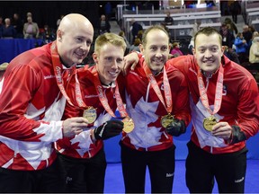 Skip Kevin Koe (left). third Marc Kennedy, second Brent Laing and lead Ben Hebert poise with their Team Canada jackets and first-place medals from the Canadian Olympic team curling trials.