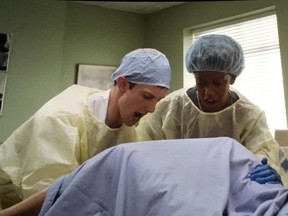 Mark Dozlaw, left, and actress Rukiya Bernard onscreen during a scene with Julia Roberts and Owen Wilson.