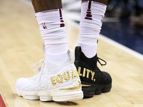 Cleveland Cavaliers forward LeBron James' shoes are emblazoned with "EQUALITY" on both heels during the first half of an NBA basketball game against the Washington Wizards, Sunday, Dec. 17, 2017, in Washington.