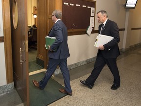 Premier Brad Wall, left, walks into the chamber for question period for the last time at the Legislative Building in Regina.