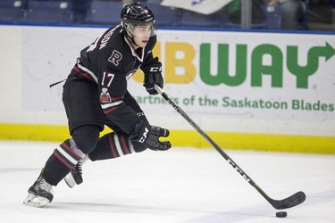 Red Deer Rebels forward  Reese Johnson moves the puck against the Saskatoon Blades during first period WHL action in Saskatoon, SK on Friday, January 5, 2017.