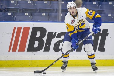 Saskatoon Blades forward  Josh Paterson moves the puck against the Red Deer Rebels in third period WHL action in Saskatoon, SK on Friday, January 5, 2017.