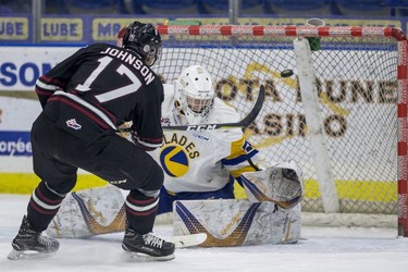 Saskatoon Blades goalie  Nolan Maier stops a high shot from Red Deer Rebels forward  Reese Johnson in third period WHL action in Saskatoon, SK on Friday, January 5, 2017.