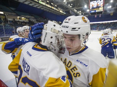 Saskatoon Blades goalie  Nolan Maier, left, and forward  Chase Wouters celebrate their win over the Red Deer Rebels in WHL action in Saskatoon, SK on Friday, January 5, 2017.