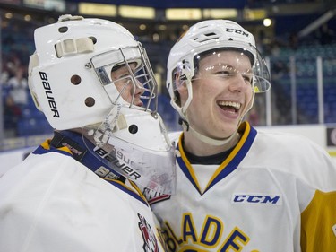 Saskatoon Blades goalie  Nolan Maier, left, and  forward  Bradly Goethals celebrate their win over the Red Deer Rebels in WHL action in Saskatoon, SK on Friday, January 5, 2017.