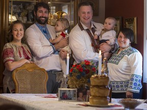 Luba Wojcichowsky, from left, Adam Peters, Veyda Peters, Clint Johnson, Maksym Johnson, and Angie Wojcichowsky, stand for a photograph at their dining room table decorated with food and items for Ukrainian Christmas in Saskatoon on Friday, January. 5, 2017.