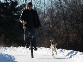 Tom Wolf takes his dog out for a unicycle ride along Saskatchewan Crescent East in Saskatoon on January 14, 2018. Wolf cycles to work and back every day, even in the winter, saying he enjoys the cold and that the unicycle provides him more of a workout.