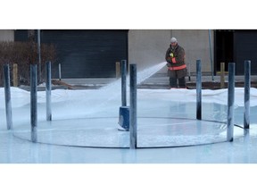 A Saskatoon firefighter floods the Crokicurl rink ahead of Winterruption in Saskatoon in January 2018.