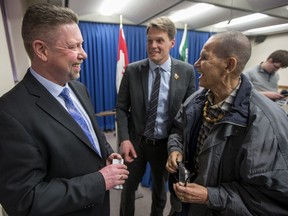 New Chief of Police for the Saskatoon Police Service Troy Cooper, left, speaks with Mayor Charlie Clark, and elder Michael Maurice following a media event at City Hall in Saskatoon, SK on Wednesday, January 17, 2018.
