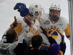 Saskatoon Blades' Eric Florchuk celebrates his game tying goal against Moose Jaw Warriors with teammate Max Gerlach during third period action at SaskTel Centre in Saskatoon, SK on January 21, 2018.