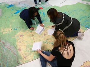 Grade 7/8 English students search for ridings on a large map of Canada at Alvin Buckwold school in Saskatoon, SK on January 22, 2018.