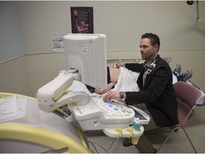 Dr. Tom Guzowski recently brought over an intestinal ultrasound machine to help Saskatchewan doctors monitor patients with Crohn's and colitis. Guzowski (right) uses the machine on a woman (name withheld) at City Hospital in Saskatoon on Wednesday, Jan. 24, 2018.