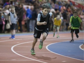 Young runners race down the track during the Knights of Columbus elementary school relay event at the Saskatoon Field House in Saskatoon, January 25, 2018.