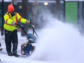 A man battles blowing snow in an attempt to clear the sidewalk downtown Saskatoon, SK on January 30, 2018.