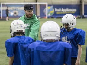 Olympic bobsledder Ben Coakwell works with youngsters at a Saskatoon football camp earlier this year.