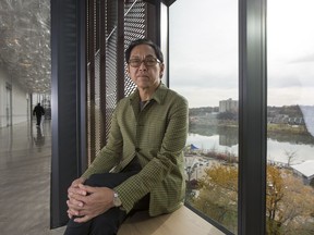 Architect Bruce Kuwabara sits near a steel mesh exterior covering that reduces heat from the sun, while allowing a view of the river from the inside of the Remai Modern Art Gallery in Saskatoon, SK on Friday, October 20, 2017.