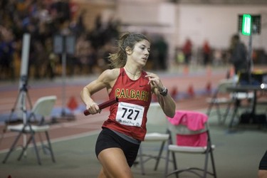 A member of the University of Calgary track team runs during the women 4x4 Relay during the University of Saskatchewan Huskies annual Sled Dog track and field meet at the Saskatoon Field House in Saskatoon, SK on Saturday, January 13, 2018.