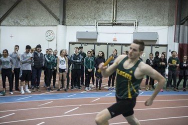 Ben Mickelsen runs past spectators during a Relay at the University of Saskatchewan Huskies annual Sled Dog track and field meet at the Saskatoon Field House in Saskatoon, SK on Saturday, January 13, 2018.