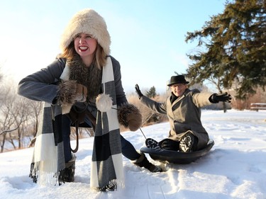 Stephanie McKay pulls Cam Fuller on a toboggan in 2017 for one of their many goofy arts department photo shoots.