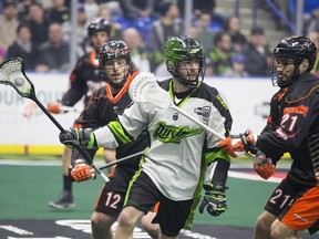 Rush forward Curtis Knight carries the ball in front of Buffalow Bandits defender Justin Martin during a NLL game Friday at SaskTel Centre.