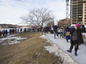 Attendants begin the march by walking towards downtown Saskatoon during the Women's March Canada event near river landing in Saskatoon, SK on Saturday, January 20, 2018.