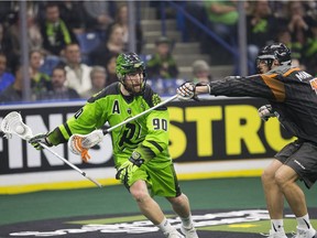 Saskatchewan's Ben McIntosh moves the ball against New England's Brett Manney during the team's recent home opener.