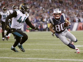 New England Patriots wide receiver Danny Amendola (80) runsto the end zone against Jacksonville Jaguars linebacker Myles Jack (44) for a touchdown after catching a pass during the second half of the AFC championship NFL football game, Sunday, Jan. 21, 2018, in Foxborough, Mass.