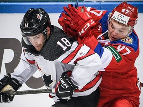 Russia's forward Kirill Kaprizov (R) vies for the puck with Canada's forward Linden Vey during the Channel One Cup of the Euro Hockey Tour ice hockey match between Canada and Russia in Moscow on December 16, 2017.