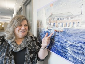 Lenora Toth, executive director of operations at the Provincial Archives of Saskatchewan points to a boat in a drawing of a boat house that was never built on Wascana Lake. The piece is part of Artful Conceptions, one of many architectural drawings on display at Government House starting Jan. 15 and running until March.