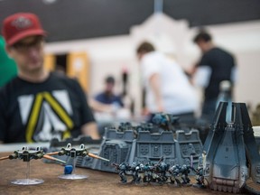 Dan Snell sits at a table playing the game Warhammer 40,000 during the Prairie Game eXpo held at the Core Ritchie Neighbourhood Centre.