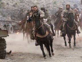 Chris Hemsworth (C) stars in "12 Strong."