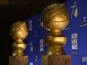 FILE - In this Monday, Dec. 11, 2017 file photo, Golden Globe statues appear on stage prior to the nominations for 75th Annual Golden Globe Awards at the Beverly Hilton hotel in Beverly Hills, Calif. The Golden Globe Awards will be handed out on Sunday, Jan. 7, 2018, at a ceremony is being held under the cloud of the sexual misconduct scandal that started with several high-profile actresses accusing Harvey Weinstein of sexual harassment or abuse. Many actresses say they are planning to wear black Sunday to show solidarity with victims of harassment and abuse.
