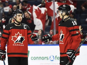 Canada's Dillon Dube, left, celebrates a goal against Switzerland with Taylor Raddysh (16) during third period quarter-final IIHF World Junior Championships hockey action in Buffalo, N.Y. on Tuesday, January 2, 2018.