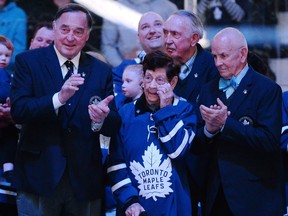 Nancy Bower, wife of the late NHL great Johnny Bower, watches a tribute to her husband with former Toronto Maple Leafs players Frank Mahovlich, left, and Dave Keon prior to NHL hockey action, between the Tampa Bay Lightning and Toronto Maple Leafs in Toronto on Tuesday, January 2, 2018.