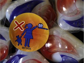 A warning label is attached to a package of Tide laundry detergent packets in Houston on Thursday, May 24, 2012. Canadian authorities are warning people to stop eating laundry detergent pods, a strange and dangerous online trend that has resulted in more than 40 hospitalizations in North America.