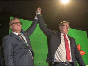 Outgoing Saskatchewan Premier Brad Wall (L) lifts the arm of Scott Moe who won the party leadership and becomes the new Saskatchewan Premier during the Saskatchewan Party Leadership Convention in Saskatoon, January 27, 2018.