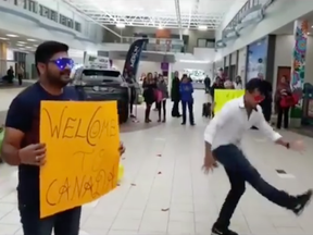 A screen shot from a video posted to the Saskatoon Airport's Facebook page shows Vaibhav Thakar (right) performing a welcome dance for his wife as she arrives in Canada.