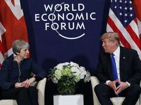 FILE - A Thursday, Jan. 25, 2018 file photo of US President Donald Trump meeting with British Prime Minister Theresa May at the World Economic Forum in Davos, Switzerland. President Donald Trump has wished Prince Harry and fiancee Meghan Markle well and says he is not aware of having received an invitation to their royal wedding in May.