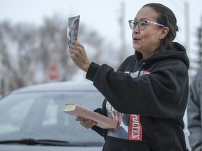 Debbie Baptiste holds a photograph of her son Colten Boushie as she enters Battleford Court of Queen's Bench at the start of Day 5 of Gerald Stanley's second-degree murder trial on Feb. 2, 2018. Stanley is charged with killing Boushie on Aug. 9, 2016.